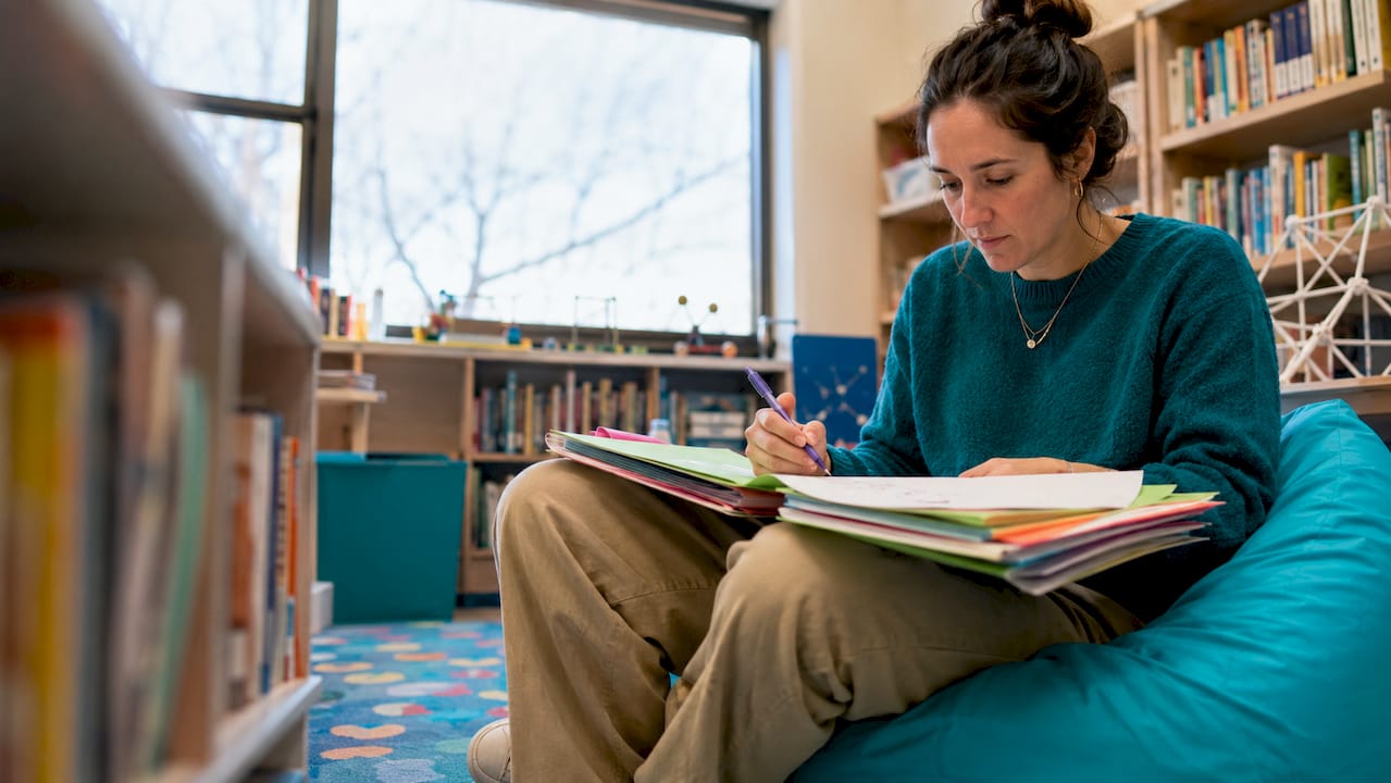 Teacher reviewing personalized STEAM student portfolios