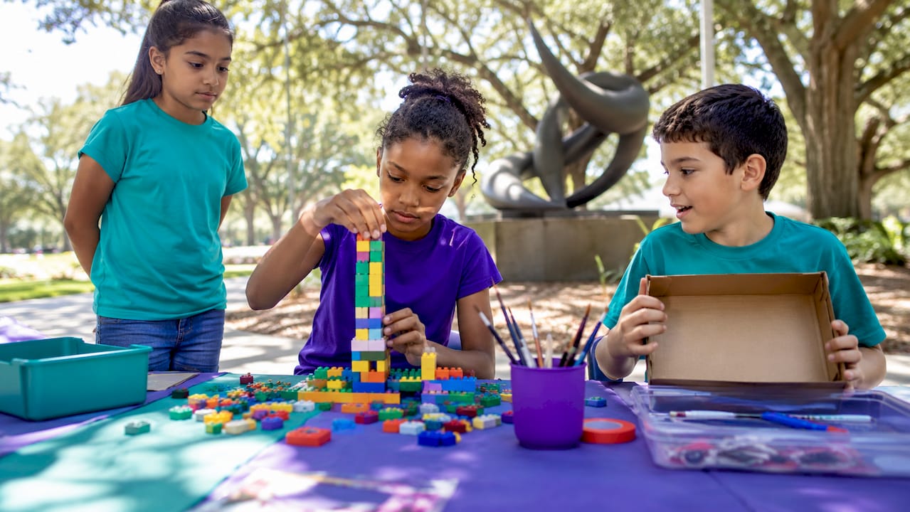 Children engaged in hands-on STEAM learning at table