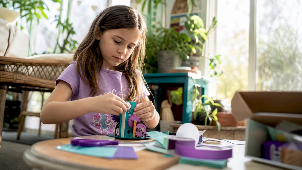 Child assembling hands-on STEAM kit parts