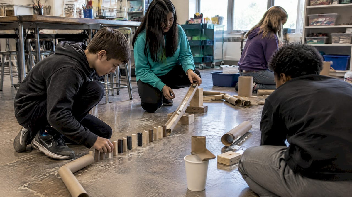 Students building a classroom chain reaction