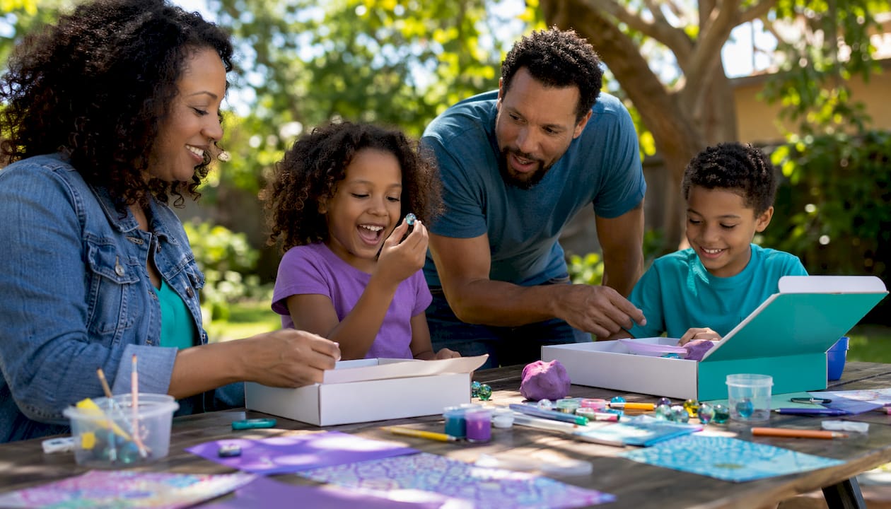Children and mother unpacking STEM educational kits at home