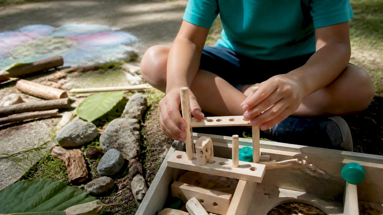 Child hands assembling STEAM project at home