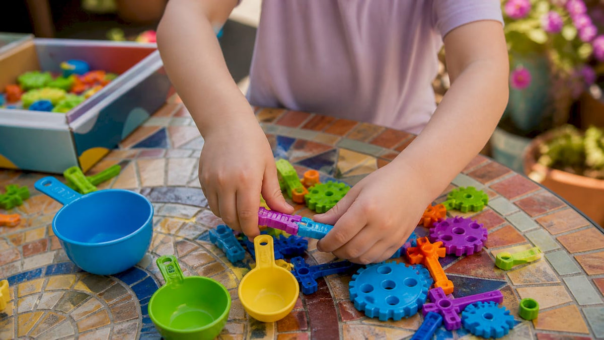 Child hands assembling STEM experiment kit