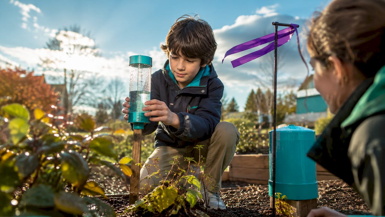 Children measuring weather outdoors