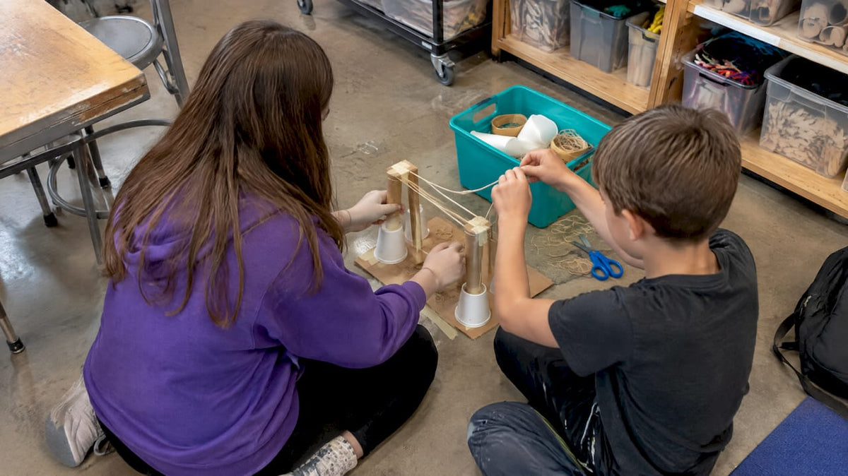 Children building a screen-free STEAM prototype