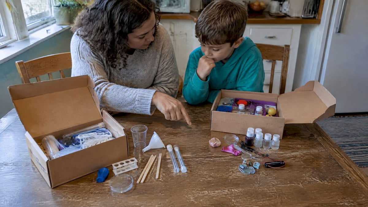 Adult and child compare science kits